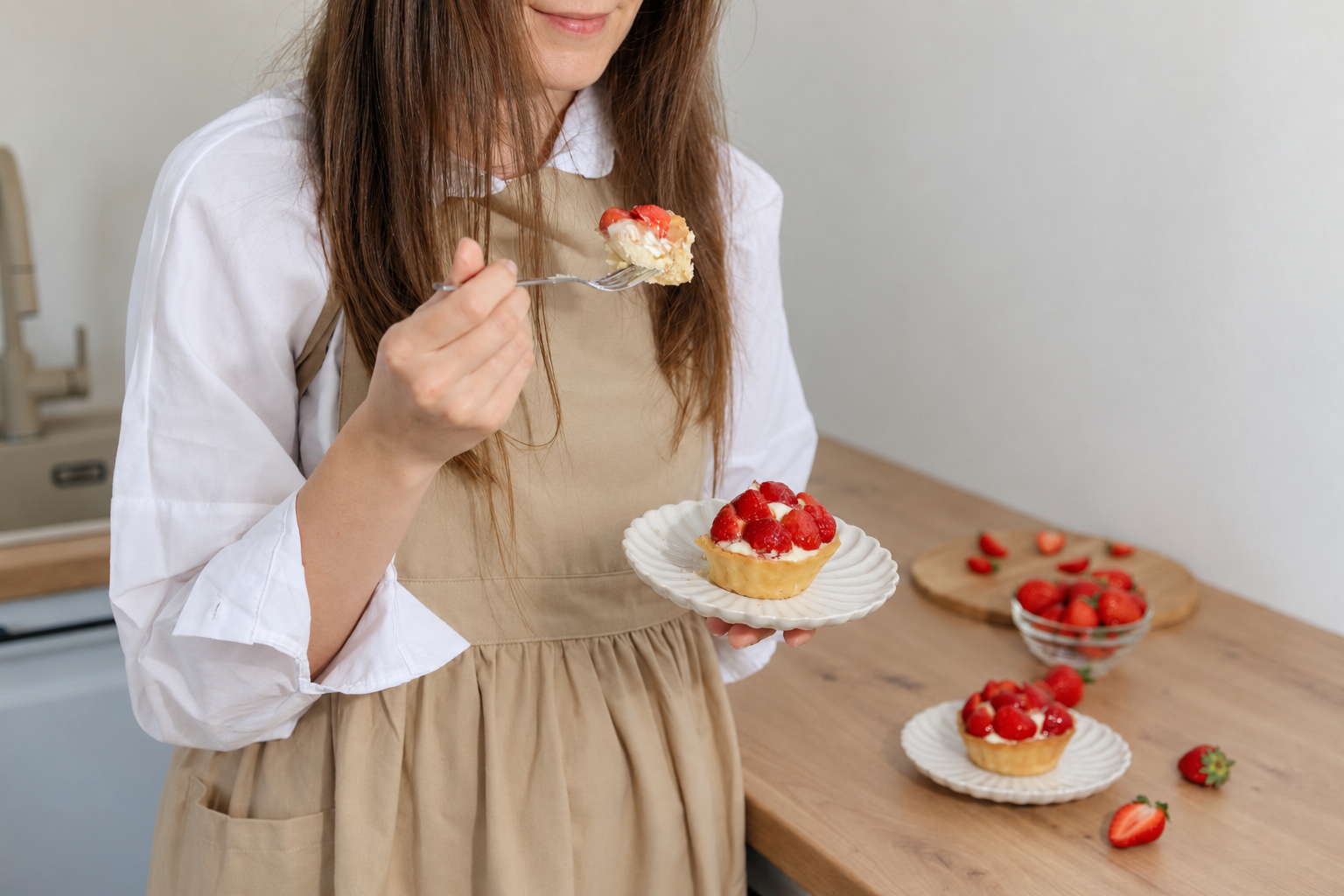 Woman eating dessert in the kitchen