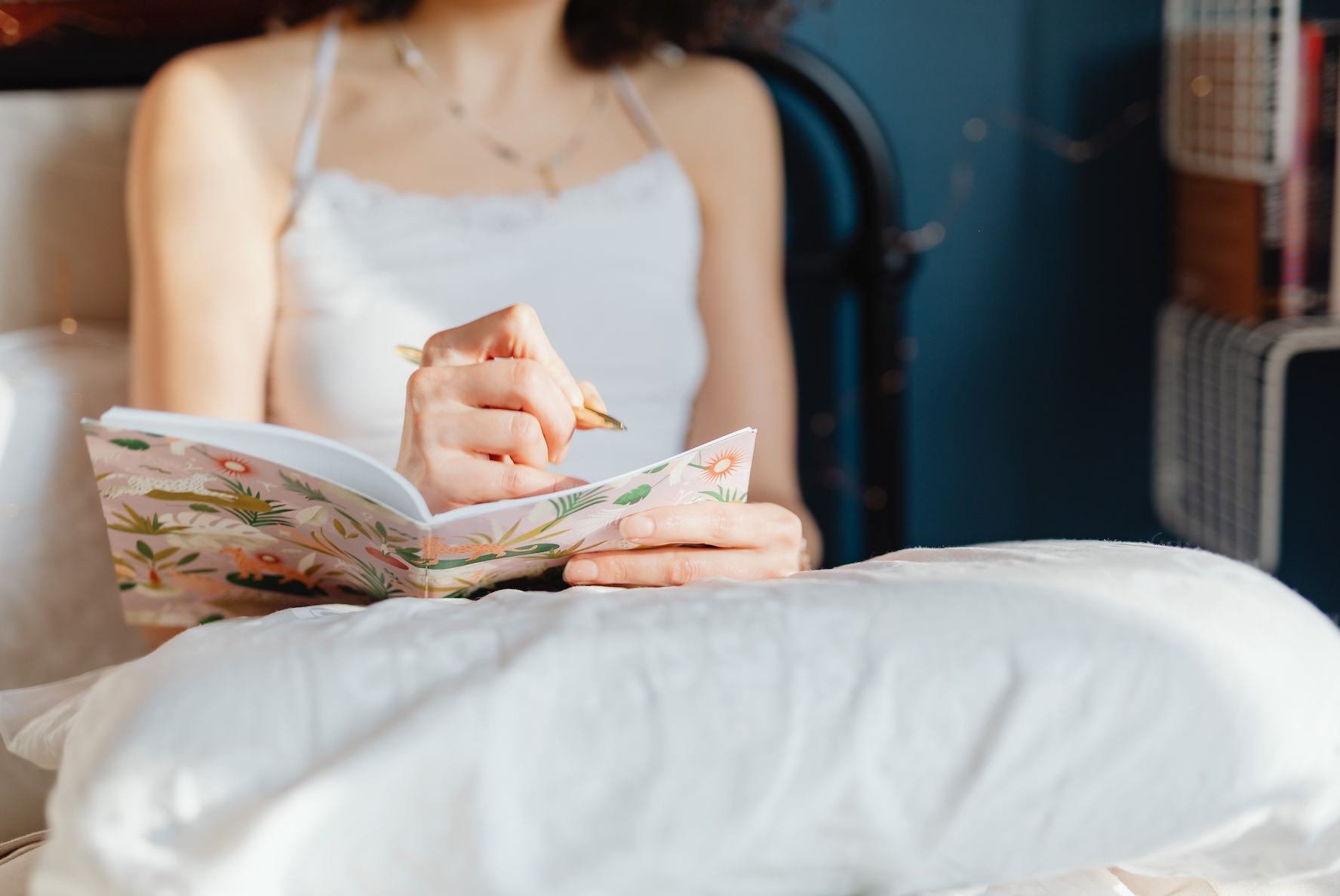 Woman writing on a journal.